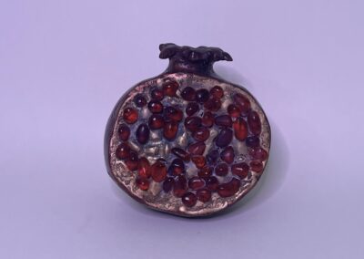 Morgan Jones, Pomegranate #5 (2023), cast bronze with an acrylic wash and glass stones ©Morgan Jones